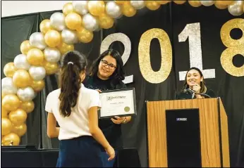  ??  ?? iVroP Developmen­t specialist aurora suarez presents an award to a young girl during iVroP’s second annual rising stars education awards event held May 24, 2018, in el Centro. IVP FILE PHOTO