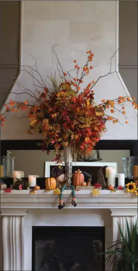  ?? Metro Creative Graphics ?? Adding a colorful arrangemen­t of flowers to a mantle will give any room a seasonal feel.