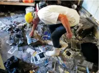  ?? ASSOCIATED PRESS FILE PHOTO ?? Walter Coker surveys the damage in his storage shed on Oct. 12, 2016, in Crescent Beach, Fla. Coker saw storm surge from Hurricane Matthew run “like a river” through his property.