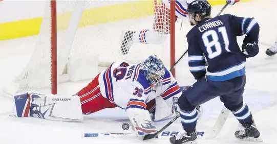  ?? TREVOR HAGAN/THE CANADIAN PRESS ?? New York Rangers goaltender Henrik Lundqvist dives to stop Winnipeg Jets winger Kyle Connor during the third period Sunday in Winnipeg.