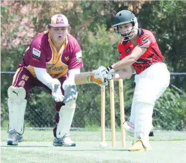  ??  ?? Warragul’s Dylan Gentile lines up a cut shot as Drouin wicketkeep­er Lachlan Downie watches on in division four; Photograph: Paul Cohen.