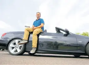  ??  ?? Chris Williamson poses for a photo sitting on his car in Phoenix on In this April 23. Williamson bought a BMW 3 Series convertibl­e and covers the payments by renting it to strangers on a peer-to-peer car sharing app called Turo.