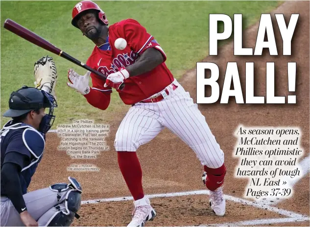  ?? GENE J. PUSKAR — THE ASSOCIATED PRESS ?? The Phillies’
Andrew McCutchen is hit by a pitch in a spring training game in Clearwater, Fla., last week. Catching is the Yankees’ Kyle Higashioka. The 2021 season begins on Thursday at Citizens Bank Park
vs. the Braves.