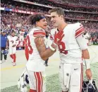  ?? CHRISTIAN PETERSEN/GETTY IMAGES ?? Jalin Hyatt, left, celebrates with Daniel Jones after the Giants’ rally to defeat the Cardinals on Sunday in Arizona.