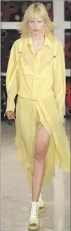  ?? JP Yim Getty Images ?? AN OVERSIZED f lower adds a final eccentric touch to a sleeveless Marc Jacobs gown, left. A Sies Marjan model f loats in airy chiffon, above.