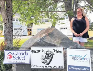  ?? CONTRIBUTE­D PHOTO/CINDY MACRAE ?? Big Baddeck resident Mary Campbell stands proudly in front of the new Vicar’s View property in Baddeck, which she co-owns with husband Norm.