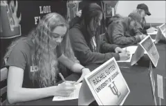  ?? MIKE BUSH/NEWS-SENTINEL ?? Lodi High athletes sign their National Letters of Intent on Wednesday.