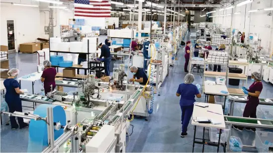  ?? DAVID SANTIAGO dsantiago@miamiheral­d.com ?? DemeTech employees on the assembly line at the company’s manufactur­ing facility in Doral on Oct. 21.