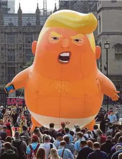  ?? EPA PIX ?? Protesters preparing to release the ‘Donald Trump Baby Blimp’ in London yesterday.