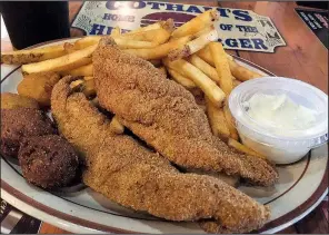  ?? Arkansas Democrat-Gazette/ERIC E. HARRISON ?? Two-piece catfish dinner at Cotham’s in the City comes with (clockwise from left) two hush puppies, two corn fritters, fries and tartar sauce.