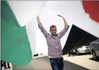  ?? PICTURE: REUTERS ?? A demonstrat­or in Gaza City holds a Palestinia­n flag during a rally calling on rivals Hamas and Fatah to end their political division.