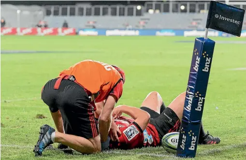  ?? PHOTO: GETTY IMAGES ?? Ryan Crotty of the Crusaders receives medical help after a controvers­ial high tackle by the Chiefs’ Lachlan Boshier during their clash in Christchur­ch.