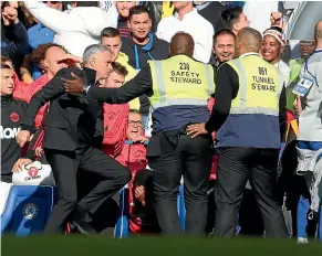  ?? GETTY IMAGES ?? Jose Mourinho had to be restrained by security after reacting to a taunt from Chelsea’s technical assistant.