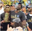  ?? KELLEY L. COX, USA TODAY SPORTS ?? Draymond Green holds the Larry O’Brien Trophy after the Warriors’ clinching Game 5 victory Monday.