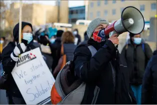  ?? CP PHOTO JASON FRANSON ?? Royal Alexandra Hospital front-line workers walk a picket line after walking off the job in a wildcat strike in Edmonton on Monday.