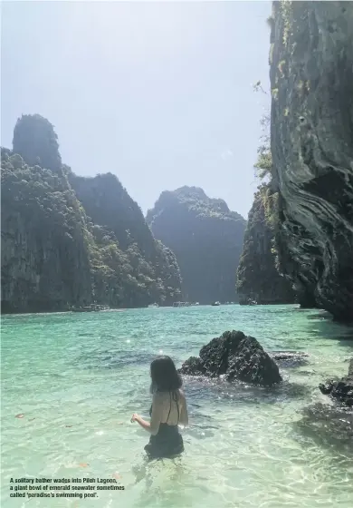  ?? ?? A solitary bather wades intoPileh Lagoon, a giant bowl of emerald seawater sometimes called ‘paradise’s swimming pool’