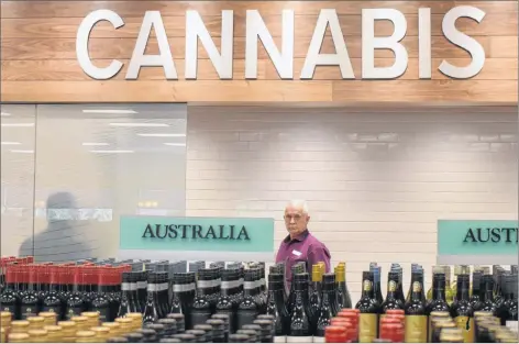  ?? DAVID JALA/CAPE BRETON POST ?? Nova Scotia Liquor Corporatio­n employee Dave MacPherson stands at the entrance to Cape Breton Island’s first and only cannabis store. The shop, which will open Oct. 17 when recreation­al marijuana becomes legal in Canada, is located inside the Nova Scotia Liquor Commission’s Sydney River outlet. The Crown corporatio­n showed off its new store on Tuesday when local news media toured the facility that in two weeks will be legally dispensing recreation­al cannabis.