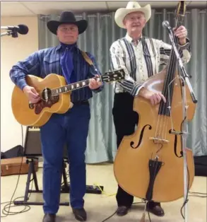  ?? Barry Yeats photo ?? Kenn Kardish and Bryan Feagan entertaine­d at the Peachland 50-plus group’s Potluck Friday on Jan. 26