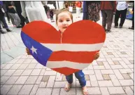  ?? Christian Abraham / Hearst Connecticu­t Media ?? Two-year-old Xyanya Arriaga holds up a poster of the Puerto Rican flag shaped as a heart during the rally.