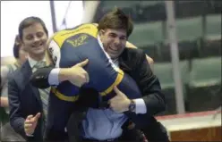  ??  ?? Averill Park Coach Mike Malenfant catches and embraces his 152-pound Section 2 Division 1 champion and son, Sean, after his dramatic win at the Cool Insuring Arena Saturday night.