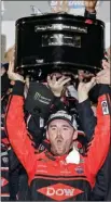  ?? The Associated Press ?? Austin Dillon raises the trophy in Victory Lane after winning the NASCAR Daytona 500 Cup series auto race at Daytona Internatio­nal Speedway on Sunday.