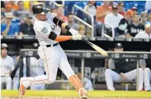  ?? ERIC ESPADA/GETTY IMAGES ?? Miguel Rojas gives the Marlins an early lead on Wednesday with a home run in the first inning at Marlins Park in Miami.