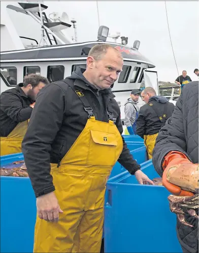  ??  ?? Boris Johnson holds a crab alongside the Carvela crab fishing boat and fisherman Karl Adamson during a visit to Stromness Harbour, Orkney in July
Picture Robert Perry