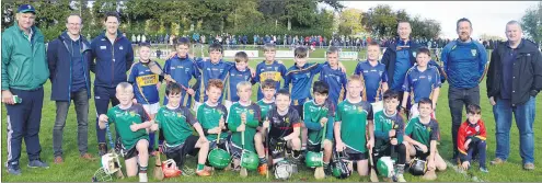  ?? (Pic: P O’Dwyer) ?? The U8s from St Dominic’s (front) and Kilshannig, with their mentors, who played at half-time during the Hibernian Hotel Avondhu JAHC final on Saturday in Castletown­roche.
