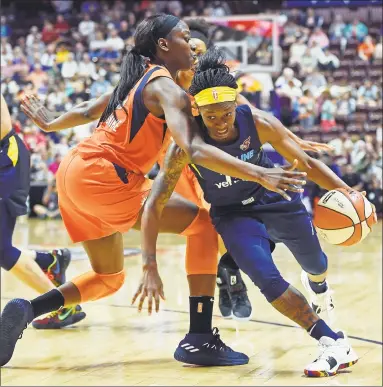  ?? Sean D. Elliot / Associated Press ?? Connecticu­t Sun forward Chiney Ogwumike, left, defends against Indiana Fever guard Erica Wheeler during a May 26 game in Uncasville.