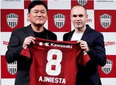  ??  ?? Iniesta (right) and Mikitani pose with Iniesta’s new team jersey at a news conference to announce signing for J-League side Vissel Kobe in Tokyo, Japan. — Reuters photo