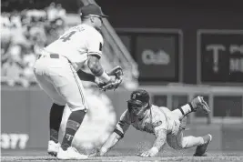  ?? MATT KROHN USA TODAY NETWORK ?? Boston's Jarren Duran slides into third base for a triple as the Twins’ Jose Miranda fields the ball Sunday.