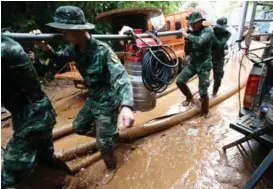  ?? FOTO: SAKCHAI LALIT, AP
FOTO: SAKCHAI LALIT, AP ?? PUMPER: Soldater baerer inn pumper for å forsøke å senke nivået på vannet i grotten der de elleve guttene og treneren deres befinner seg.