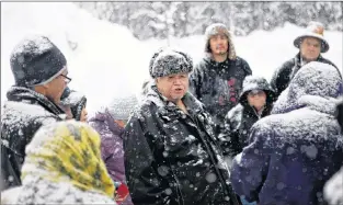  ?? CP PHOTO ?? Chief Madeek, hereditary leader of the Gidimt’en clan, talks with supporters of the Unist’ot’en camp and Wet’suwet’en people near a checkpoint camp fire off a logging road near Houston, B.C., on Wednesday.