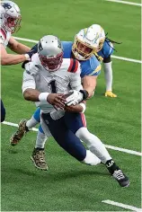  ?? AP Photo/Kelvin Kuo ?? New England Patriots quarterbac­k Cam Newton (1) is tackled by Los Angeles Chargers defensive end Joey Bosa during the first half of an NFL football game Sunday in Inglewood, Calif.