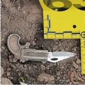  ?? COURT EXHIBIT ?? Photo of a knife found in the dirt near the porch of house where Carel Douse’s wounded body lay.