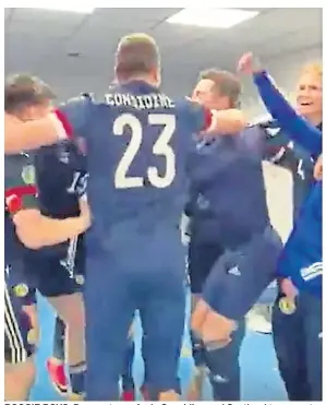  ??  ?? BOOGIE BOYS: Dons veteran Andy Considine and Scotland team-mates celebrate in the dressing room to the sound of 1970s disco act Baccara.