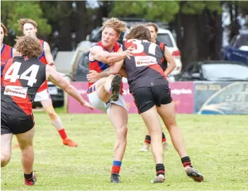  ??  ?? Buln Buln’s Matthew Notman gets his kick away as Hayden Potts provides a strong tackle for Nilma-Darnum during the Reserves match.