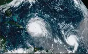  ?? ASSOCIATED PRESS ?? THIS SEPT. 7, 2017, satellite image made available by NOAA shows the eye of Hurricane Irma (left) just north of the island of Hispaniola, with Hurricane Jose (right) in the Atlantic Ocean.