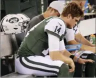  ??  ?? New York Jets quarterbac­k Sam Darnold (14) looks at his hand after hurting it during the first half of a preseason NFL football game against the Atlanta Falcons, Friday in East Rutherford, N.J.