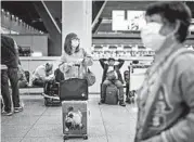  ?? HANNAH REYES MORALES/THE NEW YORK TIMES ?? Jade Doringo retrieves her luggage Feb. 4 at the airport in Manila. She was not allowed to board her flight Feb. 2.