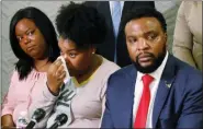  ?? IRWIN THOMPSON/THE DALLAS MORNING NEWS VIA AP ?? Amber Carr, center, wipes a tear as her sister, Ashley Carr, left, and attorney Lee Merritt, right, listen to Amber and Ashley’s brother Adarius Carr talk about their sister Atatiana Jefferson during a news conference, Monday, Oct. 14, 2019, in downtown Dallas. Jefferson was shot and killed by a white police officer in her Fort Worth home as she played video games with her 8-year-old nephew.