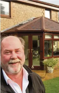  ??  ?? New roof Tom Middleton of Caledonian Windows outside the Mould household in Ayr with its new conservato­ry