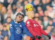  ?? Jon Super/Associated Press ?? Chelsea’s Carney Chukwuemek­a, left, jumps for a header with Liverpool’s Fabinho during the English Premier League match at Anfield stadium in Liverpool on Saturday.