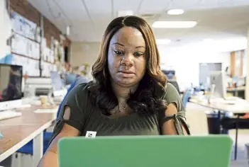  ?? Gerry Broome, The Associated Press ?? Dana Anthony works at her desk at The Daily Tar Heel newspaper in Chapel Hill, N.C., in April. Anthony was rejected after two separate Hirevue interviews for other jobs recently.