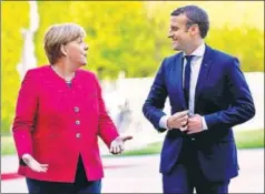  ?? REUTERS PHOTO ?? German Chancellor Angela Merkel and French President Emannuel Macron talk as they arrive at a ceremony at the Chanceller­y in Berlin, Germany, May 15, 2017.