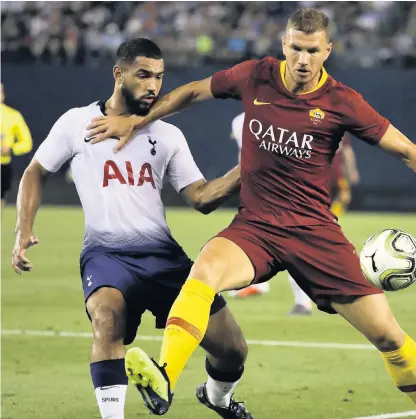  ??  ?? Cameron Carter-Vickers (left) battles Roma forward Edin Dzeko during a summer friendly in San Diego.