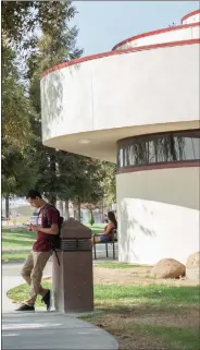  ??  ?? A student waits for a ride at Portervill­e College after class Monday afternoon. PC received multiple awards this past month, including a ranking denoting it as one of the top two community colleges in the state.