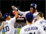  ?? MATT SLOCUM ?? Los Angeles Dodgers' Justin Turner celebrates his two-run home run during the sixth inning of Game 1 of baseball's World Series against the Houston Astros Tuesday in Los Angeles.