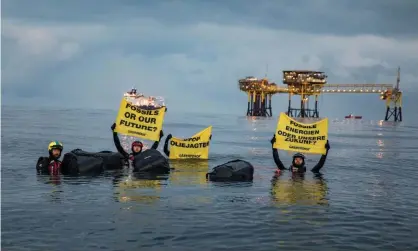  ??  ?? Greenpeace activists protest against new oil and gas exploratio­n in Denmark’s Dan oilfield in the North Sea last summer. Photograph: Andrew McConnell/Greenpeace/EPA