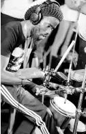  ??  ?? Percussion­ist Hector Lewis shows his versatilit­y on the multi-percussion rack and hand drums.